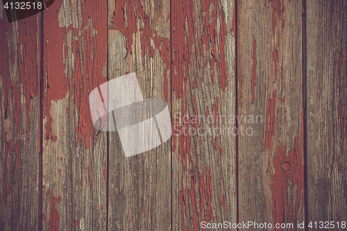 Image of Red paint pealing off wooden planks