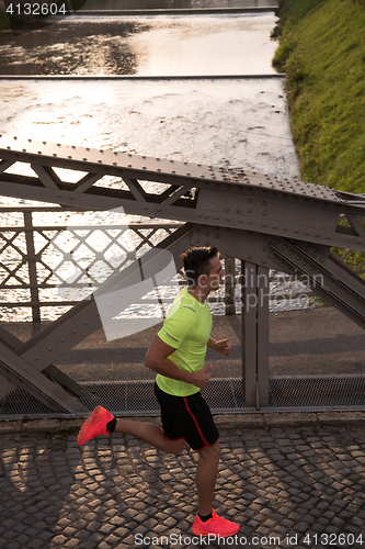 Image of a young man jogging in the city