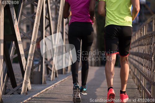 Image of multiethnic couple jogging in the city