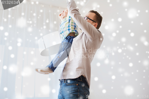 Image of father with son playing and having fun at home