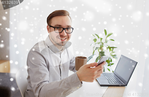 Image of happy businessman with smarphone and coffee