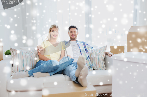 Image of happy couple with big cardboard boxes at new home