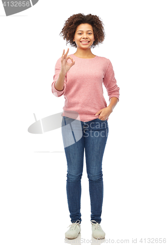 Image of happy african american young woman showing ok sign
