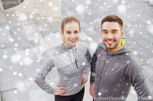 Image of happy couple of sportsmen outdoors on city street