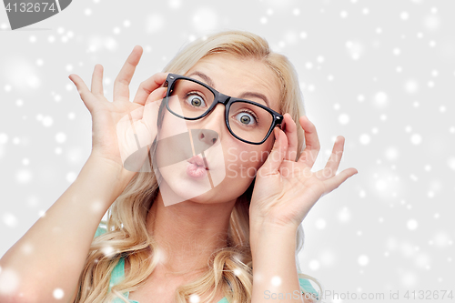 Image of happy young woman in glasses making fish face