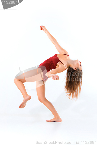 Image of Young beautiful dancer in beige dress dancing on white background