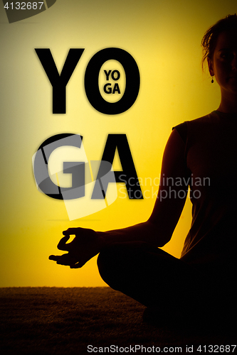 Image of The woman practicing yoga in the sunset light