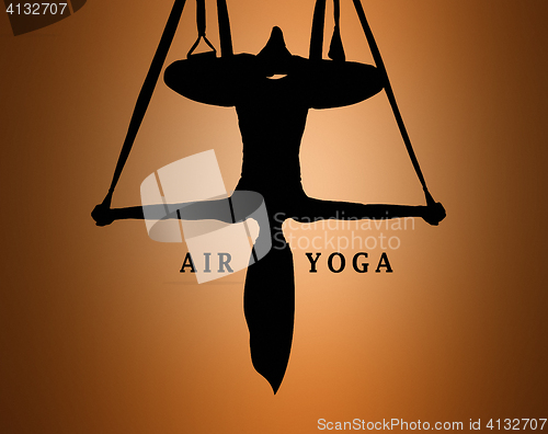 Image of The silhouette of Young woman doing anti-gravity aerial yoga