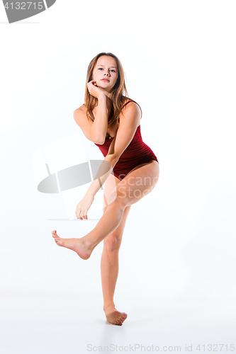 Image of Young beautiful dancer in beige dress dancing on white background