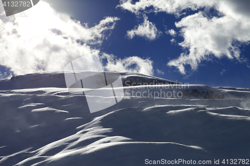 Image of Off-piste slope during blizzard and sunlight blue sky with cloud