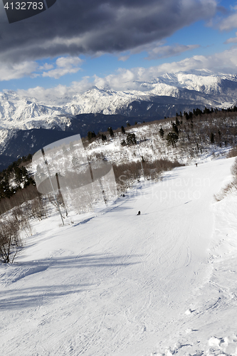Image of Skiers on ski slope at sun winter day