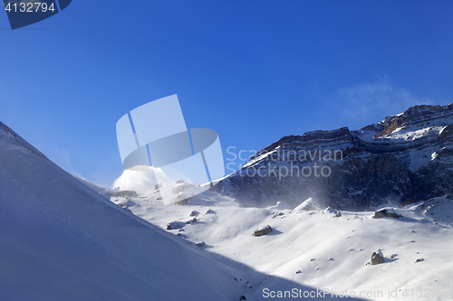 Image of Off-piste slope during blizzard and sunlight blue sky