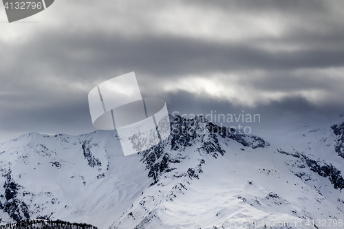 Image of Snow mountains in haze and storm clouds before blizzard