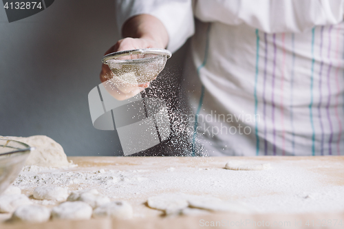 Image of Two hands making dough for meat dumplings.