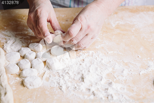 Image of Two hands making dough for meat dumplings.