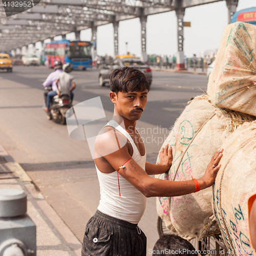 Image of Man with load on the Howrah Bridge