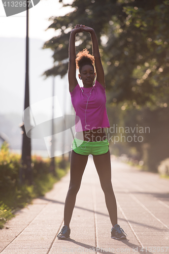 Image of Black woman doing warming up and stretching