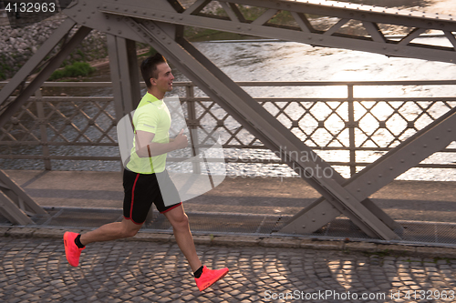 Image of a young man jogging in the city