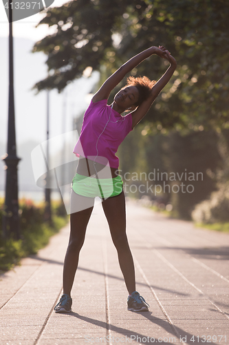 Image of Black woman doing warming up and stretching