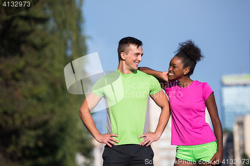 Image of portrait of young multietnic jogging couple ready to run
