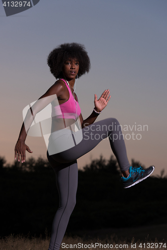 Image of black woman is doing stretching exercise relaxing and warm up
