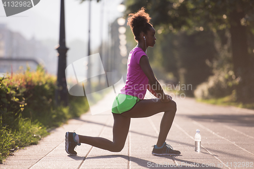 Image of Black woman doing warming up and stretching
