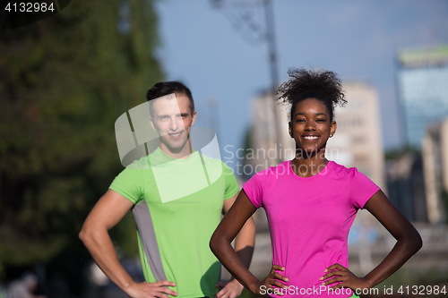 Image of portrait of young multietnic jogging couple ready to run