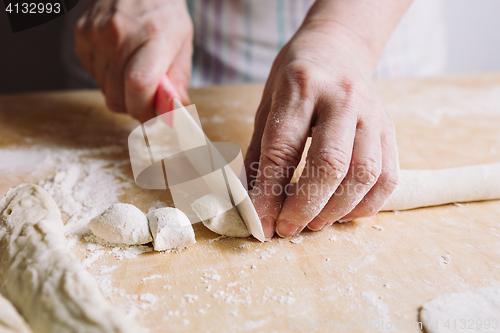 Image of Two hands making dough for meat dumplings.