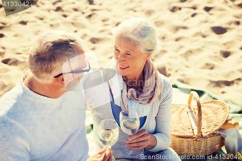 Image of happy senior couple talking on summer beach