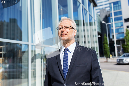 Image of senior businessman on city street