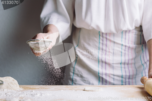 Image of Two hands making dough for meat dumplings.