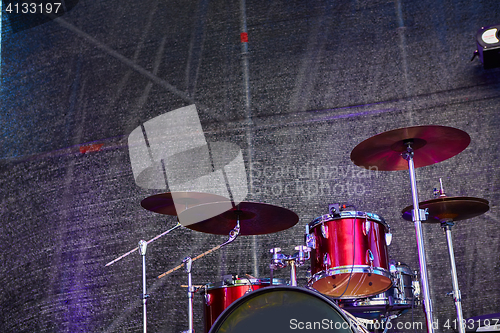 Image of Modern drum set on stage prepared for playing.
