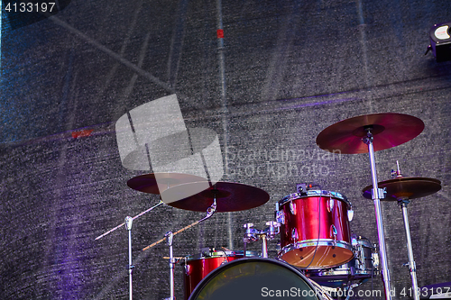 Image of Modern drum set on stage prepared for playing.