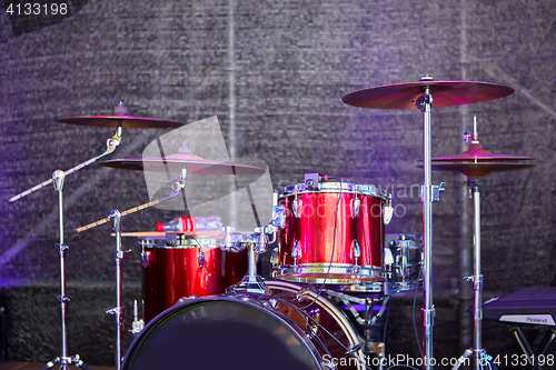 Image of Modern drum set on stage prepared for playing.