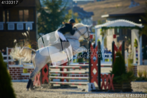 Image of Rider on bay horse in competitions. Jumping show.