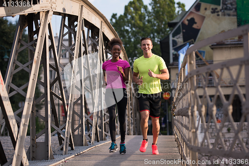Image of multiethnic couple jogging in the city
