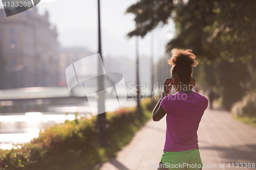 Image of portrait of young african american jogging woman