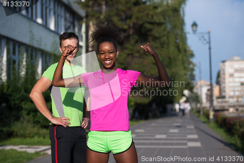 Image of portrait of young multietnic jogging couple ready to run