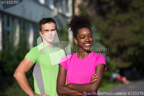 Image of portrait of young multietnic jogging couple ready to run