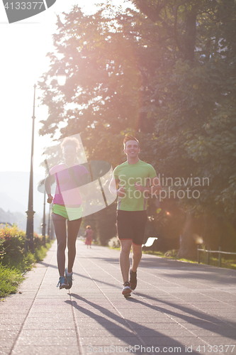Image of young multiethnic couple jogging in the city