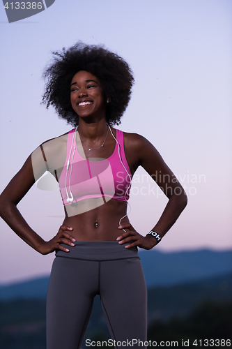 Image of portrait of african american woman jogging in nature