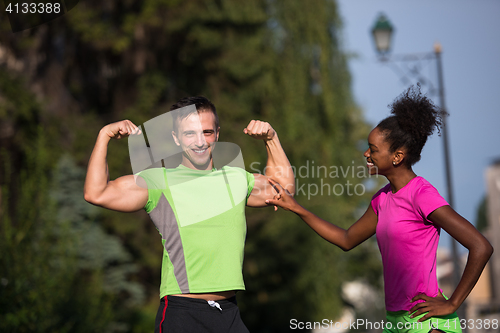 Image of portrait of young multietnic jogging couple ready to run