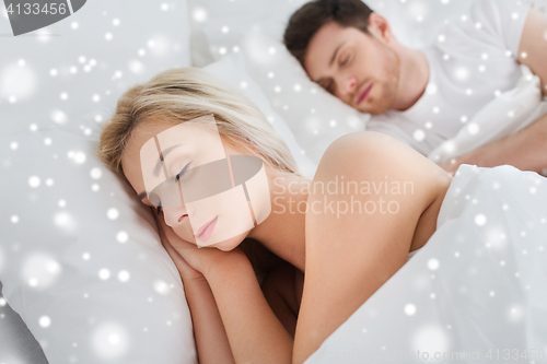 Image of happy couple sleeping in bed at home