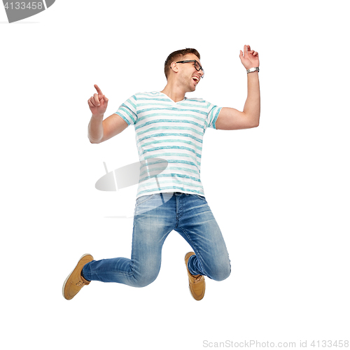 Image of happy young man jumping in air