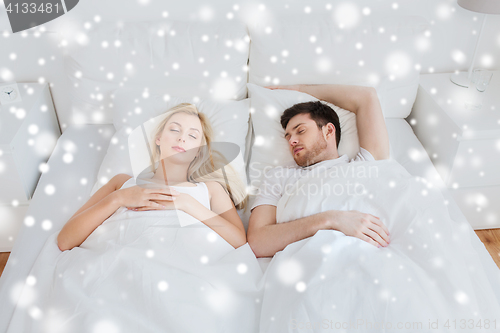 Image of happy couple sleeping in bed at home