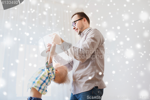 Image of father with son playing and having fun at home