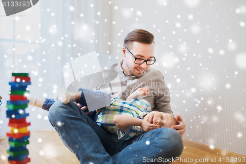 Image of father with son playing and having fun at home