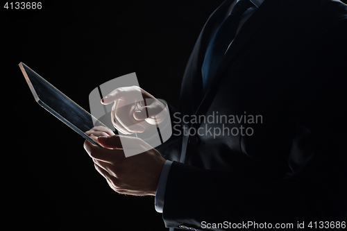 Image of close up of businessman with transparent tablet pc