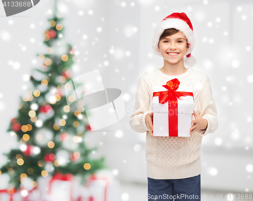 Image of smiling happy boy in santa hat with gift box