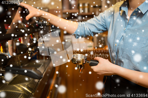 Image of close up of woman making coffee by machine at cafe